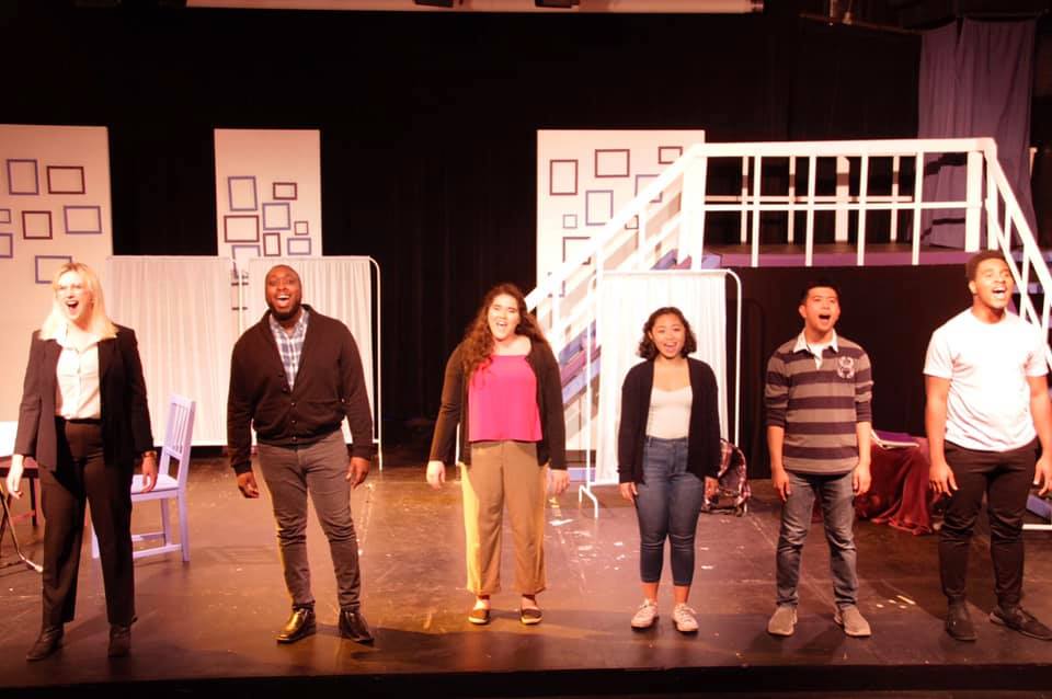 Six people in line on a small stage perform the finale to Next to Normal.